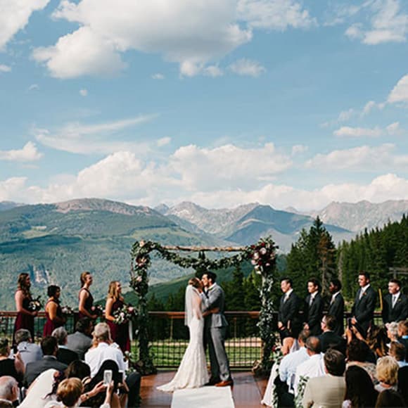 A wedding ceremony in Vail with mountains in the background.