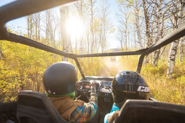 Couple driving an ATV in the fall near Vail, Colorado.