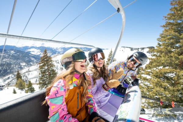 3 friends on a ski lift hanging out