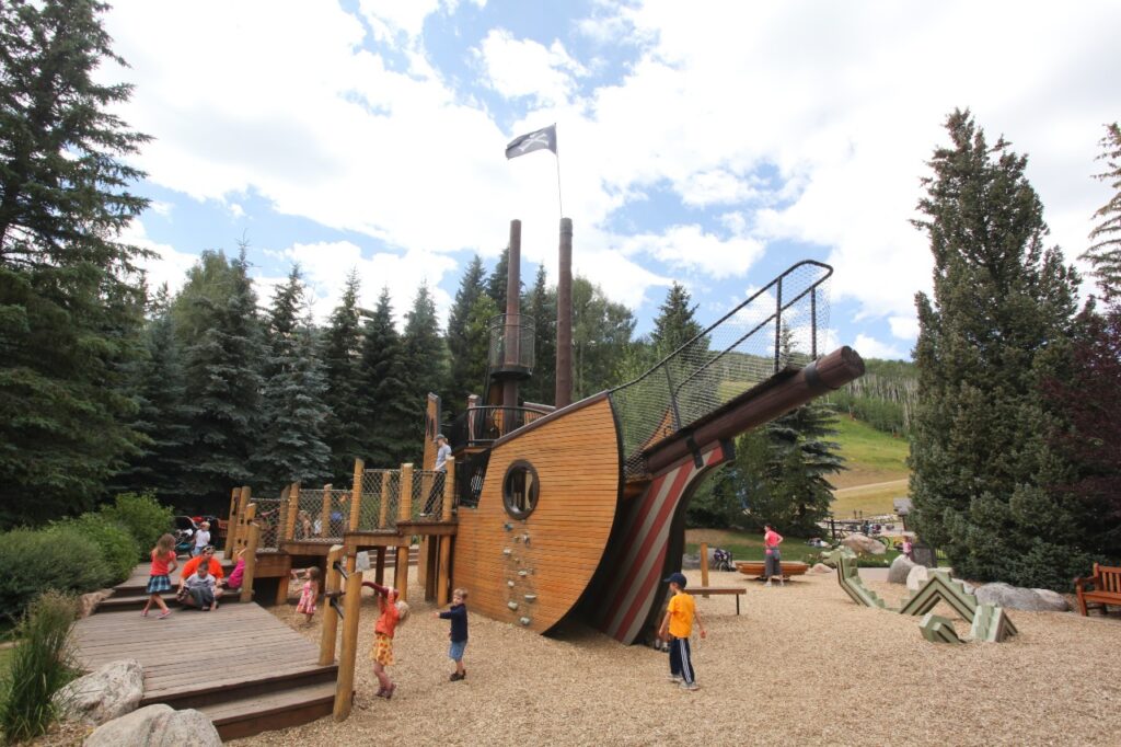 Kids playing on wooden ship at Pirateship Park