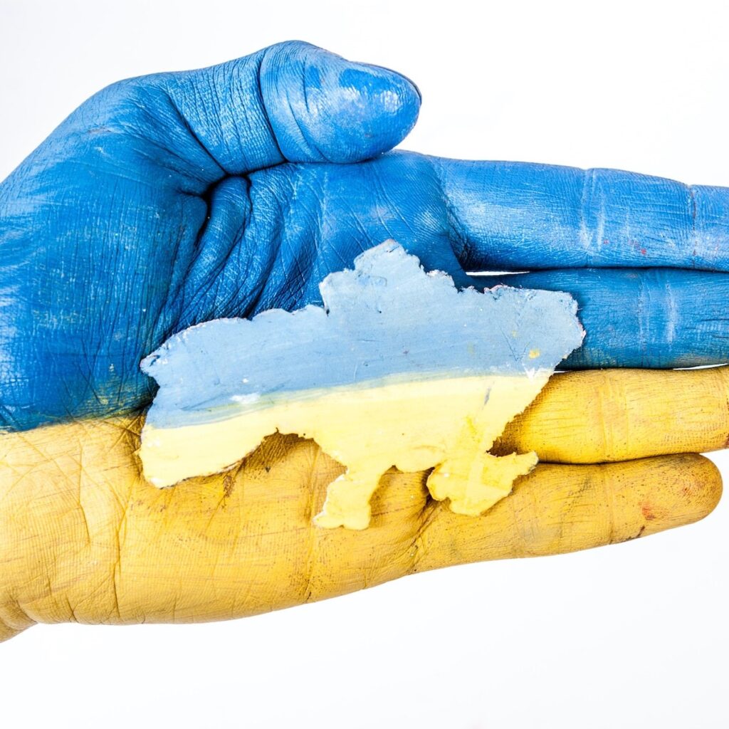 A hand holding a map of ukraine.