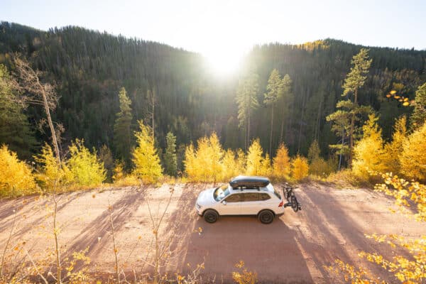 A car in the fall driving in vail mountains