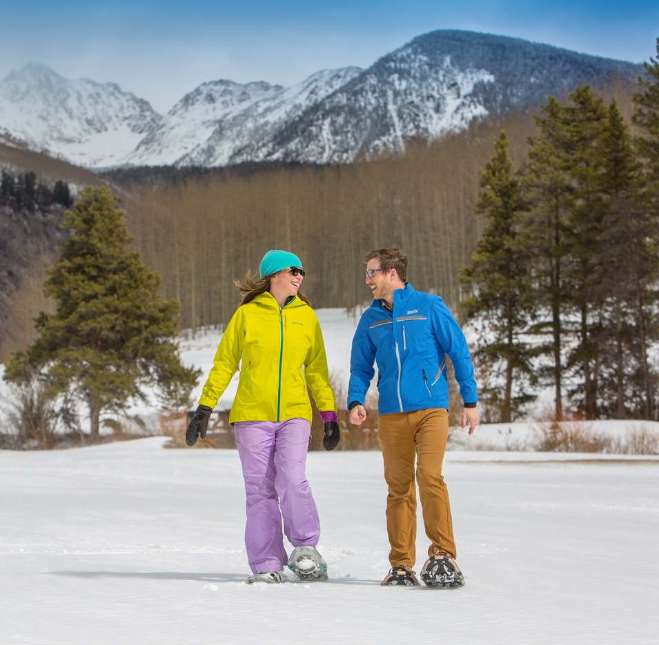 couple standing in front of snow-covered mountain in Vail