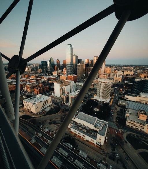 A view of a city from the top of a ferris wheel.