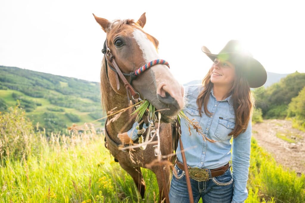 A girl and horse posing for picture at Vail Stables in Colorado.