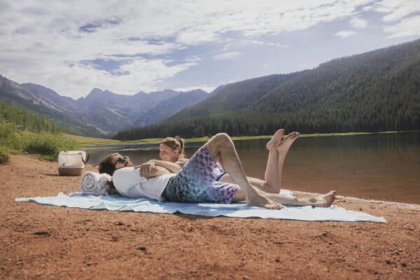 a couple laying down by piney lake