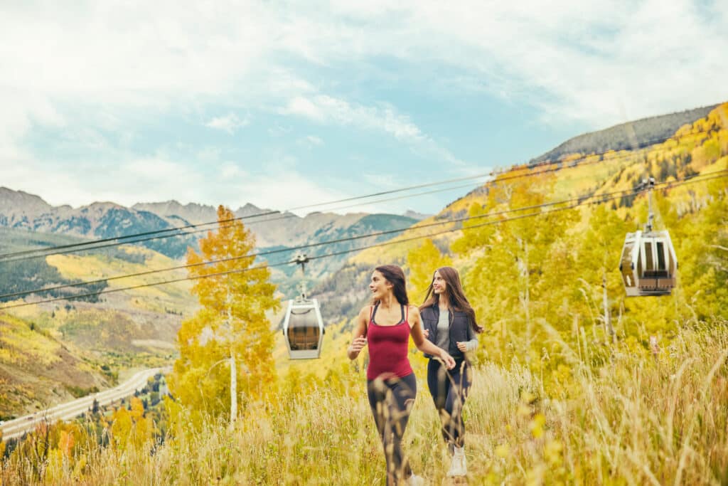two girls hiking on vail mountain in the fall
