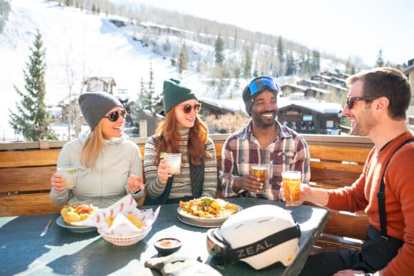 A group of four friends enjoy Mexican dishes and post-skiing drinks in Vail, Colorado.