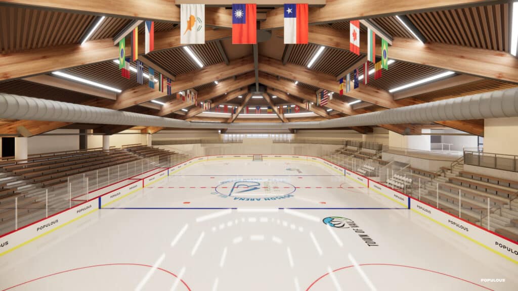 A rendering of an aerial view of the event floor at Dobson Arena. The floor level is set for hockey. There are bleacher stands to the left and right and various country flags hanging from the ceiling.