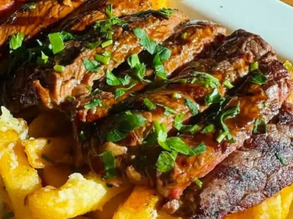 Close-up view of a sliced steak over French fries at Vail Chophouse in Vail, Colorado