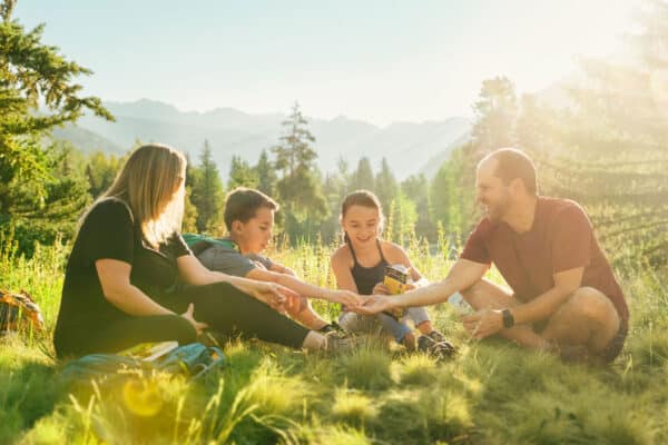 Family enjoys picnic on the top of a mountain in vail during the day